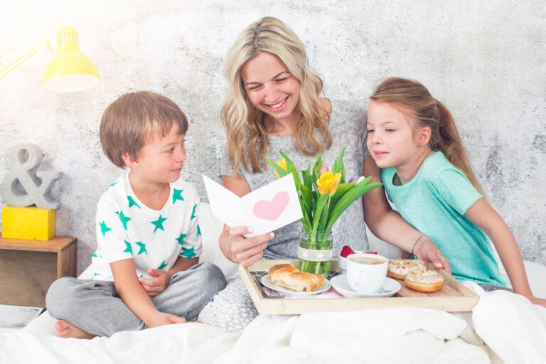 Mother´s-Day-two-children-surprise-their-mother-with-breakfast-in-modern-bed